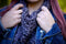 A closeup shot of the Triangulate cowl in the 'Plomo' colourway, worn underneath a unbuttoned jean jacket