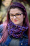 A young woman wearing glasses with multi coloured hair wears our Fluff Cowl. Shown in Quequay.