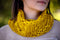 Our Slant Cowl worn by a young woman in a forest. Shown in Ochre